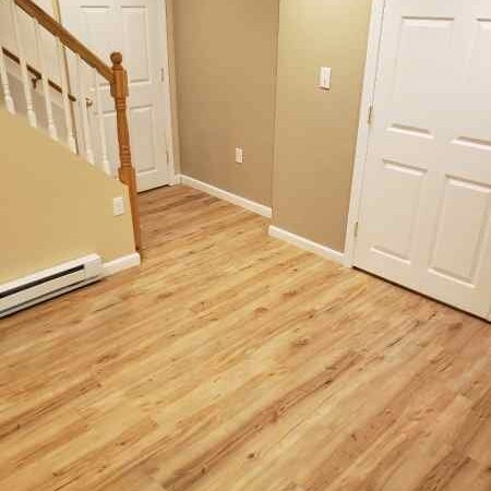Vinyl plank flooring installation by Sunshine Carpet & Flooring in North Chelmsford, MA – wood-look vinyl in a cozy family room