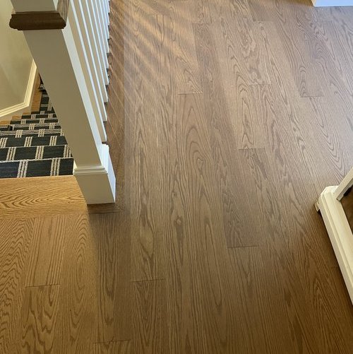 Hardwood flooring installation by Sunshine Carpet & Flooring in North Chelmsford, MA – wide-plank oak in a modern living room
