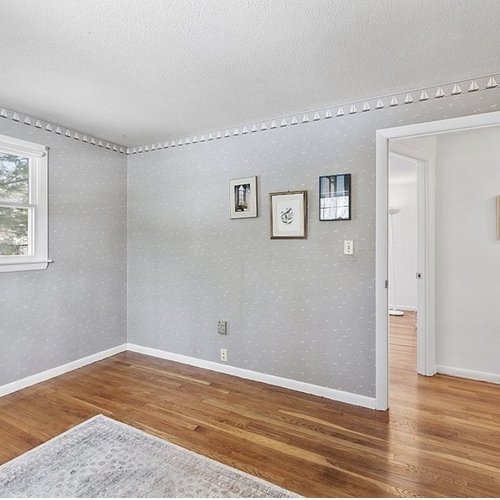 Hardwood flooring installation by Sunshine Carpet & Flooring in North Chelmsford, MA – wide-plank oak in a modern living room