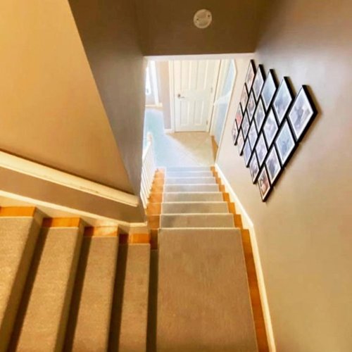 Custom stair runner installation by Sunshine Carpet & Flooring in North Chelmsford, MA – classic patterned runner on hardwood stairs