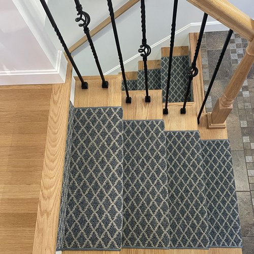 Custom stair runner installation by Sunshine Carpet & Flooring in North Chelmsford, MA – classic patterned runner on hardwood stairs