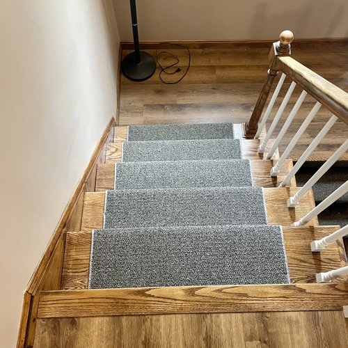 Custom stair runner installation by Sunshine Carpet & Flooring in North Chelmsford, MA – classic patterned runner on hardwood stairs