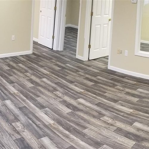 Vinyl plank flooring installation by Sunshine Carpet & Flooring in North Chelmsford, MA – wood-look vinyl in a cozy family room