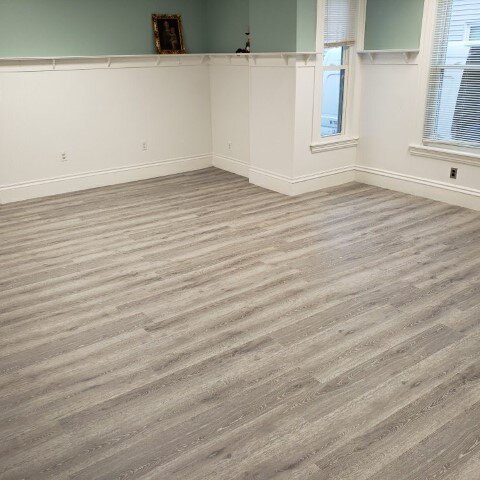 Vinyl plank flooring installation by Sunshine Carpet & Flooring in North Chelmsford, MA – wood-look vinyl in a cozy family room