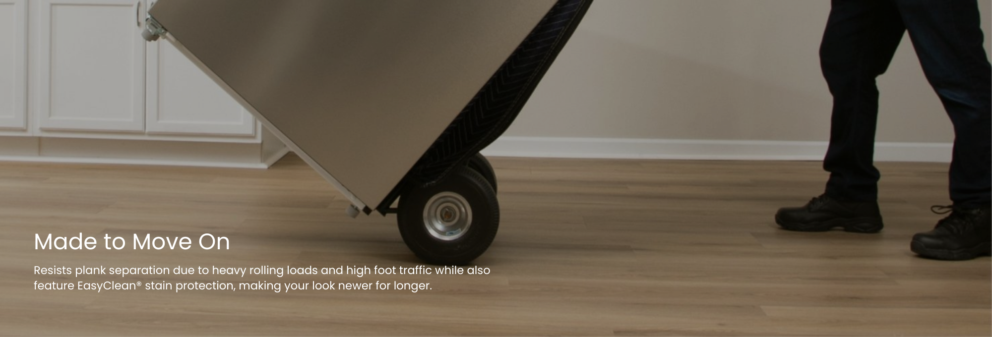 Moving a heavy fridge on a dolly across a durable vinyl floor