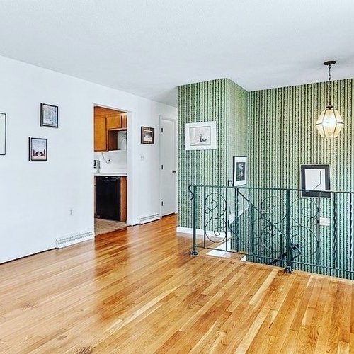 Hardwood flooring installation by Sunshine Carpet & Flooring in North Chelmsford, MA – wide-plank oak in a modern living room