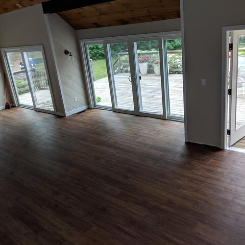 Vinyl plank flooring installation by Sunshine Carpet & Flooring in North Chelmsford, MA – wood-look vinyl in a cozy family room