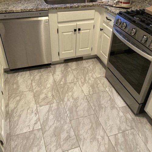 Vinyl plank flooring installation by Sunshine Carpet & Flooring in North Chelmsford, MA – wood-look vinyl in a cozy family room