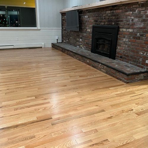 Hardwood flooring installation by Sunshine Carpet & Flooring in North Chelmsford, MA – wide-plank oak in a modern living room