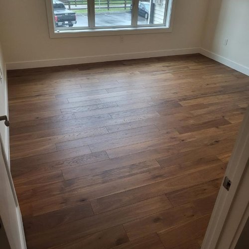 Hardwood flooring installation by Sunshine Carpet & Flooring in North Chelmsford, MA – wide-plank oak in a modern living room