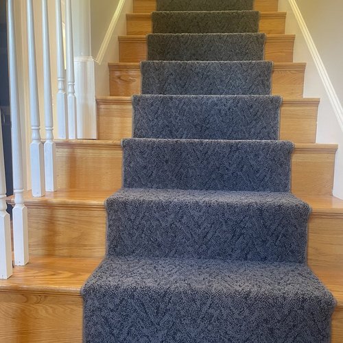 Custom stair runner installation by Sunshine Carpet & Flooring in North Chelmsford, MA – classic patterned runner on hardwood stairs