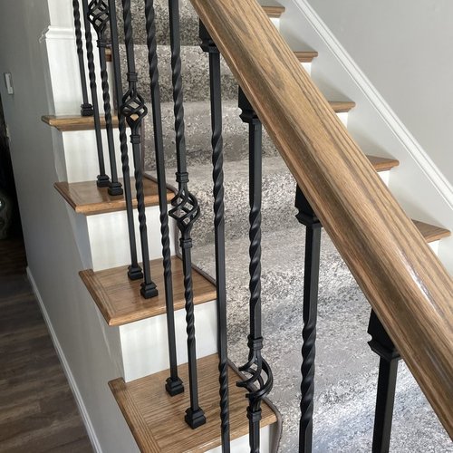 Custom stair runner installation by Sunshine Carpet & Flooring in North Chelmsford, MA – classic patterned runner on hardwood stairs