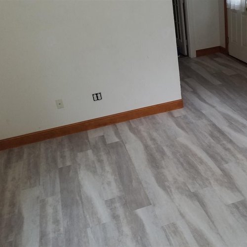 Vinyl plank flooring installation by Sunshine Carpet & Flooring in North Chelmsford, MA – wood-look vinyl in a cozy family room