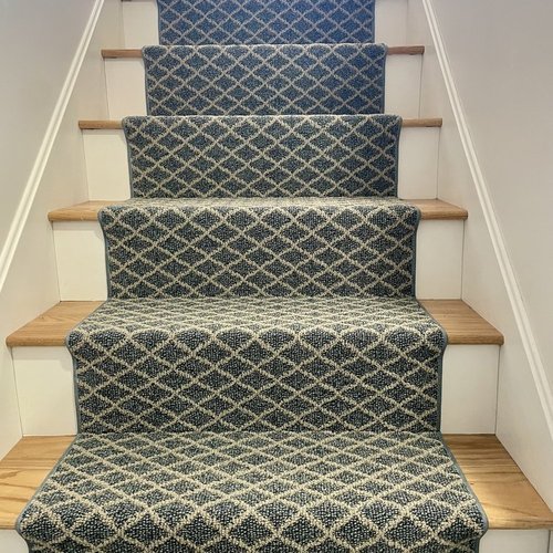 Custom stair runner installation by Sunshine Carpet & Flooring in North Chelmsford, MA – classic patterned runner on hardwood stairs