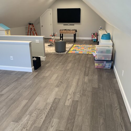 Hardwood flooring installation by Sunshine Carpet & Flooring in North Chelmsford, MA – wide-plank oak in a modern living room